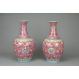 A PAIR OF CHINESE RUBY GROUND PORCELAIN VASES, DAOGUANG MARK. Decorated in famille rose enamels with