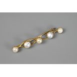 A CHINESE 20KT YELLOW GOLD AND PEARL MOUNTED BROOCH. Mounted with five graduated pearls within