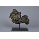 A CHINESE CAST BRONZE FIGURE OF APSARA. The flying female spirit dressed in robes playing a drum.