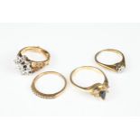 FOUR VARIOUS 9CT YELLOW GOLD STONE SET RINGS. Comprising: a diamond solitaire, a blue marquise stone
