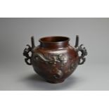 A JAPANESE MEIJI PERIOD (1868-1912) BRONZE TWO-HANDLED GLOBULAR VASE. Decorated in high relief