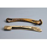 TWO JAPANESE EDO PERIOD (MID-19TH CENTURY) STAG ANTLER PIPE CASES (KISERUZUTSU). The first carved