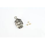 A JAPANESE SILVER LOCKETT PENDANT WITH MINIATURE DICE, EARLY 20TH CENTURY. In the form of a man