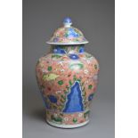 A CHINESE WUCAI PORCELAIN HORSE JAR AND COVER, PROBABLY 18TH CENTURY. Of baluster form with wide