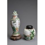 TWO CHINESE FAMILLE VERTE PORCELAIN ITEMS, 19TH CENTURY. To include a vase and cover decorated