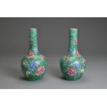 A PAIR OF CHINESE PORCELAIN BOTTLE VASES, 19TH CENTURY. Green ground decorated with peony