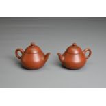 A PAIR OF SMALL CHINESE YIXING POTTERY TEAPOTS, MENG CHENG MARK. Undecorated with inscribed poem