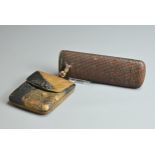 A JAPANESE MEIJI PERIOD (1868-1912) WOVEN BAMBOO PIPE CASE AND A LEATHER CIGARETTE CASE. The first