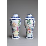 A PAIR OF CHINESE FAMILLE ROSE PORCELAIN VASES, QIANLONG, 18TH CENTURY. Of baluster form decorated