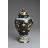 A CHINESE CLOISONNE ENAMEL VASE AND COVER, EARLY 20TH CENTURY. Black ground with dragons chasing