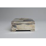 A 20TH CENTURY JAPANESE WHITE METAL AND ENAMEL MOUNTED WOODEN RECTANGULAR BOX. The top applied