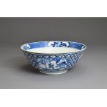 A CHINESE BLUE AND WHITE PORCELAIN BOWL, 19TH CENTURY. Decorated with panels of figures and floral