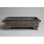 A 20TH CENTURY JAPANESE BRONZE RECTANGULAR TWO-HANDLED FOOTED JARDINIÈRE. Cast with dragons,