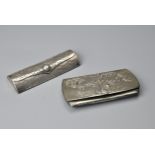 TWO CHINESE SILVER SPECTACLE CASES, EARLY 20TH CENTURY. One decorated with dragons, stamped Ju Yuan;