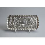 A VICTORIAN SILVER EMBOSSED RECTANGULAR DRESSING-TABLE TRAY. Hallmarked London, 1894, makers marks