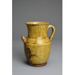 A CHANGSHA TYPE GLAZED STONEWARE EWER COATED IN A FINELY CRACKLED YELLOWISH GREEN GLAZE. Below the