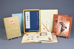 FOUR CHINESE COMMEMORATIVE STAMP BOOKS, 20TH CENTURY. To include Guangzhou city commemorative