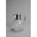 AN EDWARDIAN SILVER-PLATED CUT-GLASS 'GOLF BALL' CLARET JUG. With silver-plate golf ball finial, the