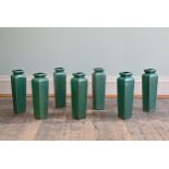 SEVEN CHINESE-STYLE GREEN-GROUND TAPERING SQUARE SECTION VASES, 20TH CENTURY. Of shouldered form,