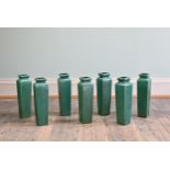 SEVEN CHINESE-STYLE GREEN-GROUND TAPERING SQUARE SECTION VASES, 20TH CENTURY. Of shouldered form,