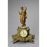 A LATE 19TH CENTURY FRENCH GILT-METAL AND ONYX MOUNTED FIGURAL MANTEL CLOCK. Surmounted with a