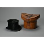 A MID-CENTURY BLACK TOP HAT FITTED IN BROWN LEATHER HAT BOX IMPORTED BY A.E. WALLERIUS & CO. Bearing