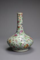 A CHINESE CELADON GROUND FAMILLE ROSE PORCELAIN BOTTLE VASE, 19TH CENTURY. Squat globular body