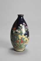 A JAPANESE CLOISONNE ENAMEL VASE, MEIJI PERIOD. Of ovoid form in a dark blue ground decorated with