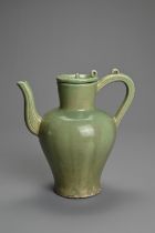 AN EAST ASIAN CELADON GLAZED PORCELAIN EWER, POSSIBLY KOREAN. Of baluster form with incised handle