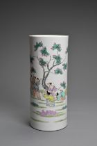 A CHINESE FAMILLE ROSE PORCELAIN VASE, 20TH CENTURY. Of cylindrical form decorated with children