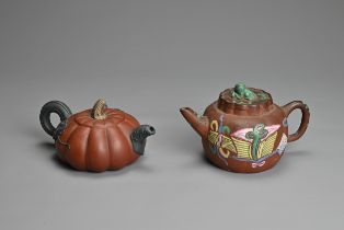 TWO CHINESE YIXING POTTERY TEA POTS, EARLY 20TH CENTURY. A rounded tea pot decorated with green,