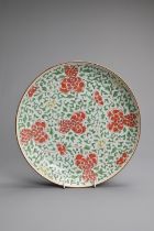 A CHINESE WUCAI PORCELAIN DISH, 17/18TH CENTURY. Decorated with peony blooms and foliage, with brown