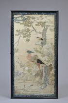 A CHINESE QING DYNASTY EMBROIDERED SILK PANEL. Of rectangular form, depicting a phoenix perched on