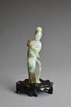 A CHINESE CARVED JADE FIGURE OF GUANYIN, QING DYNASTY. The figure standing dressed in robes