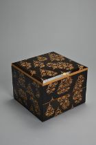 A 20TH CENTURY JAPANESE BLACK LACQUER TWO-TIER JUBAKO BOX. Of square section, decorated in gilding