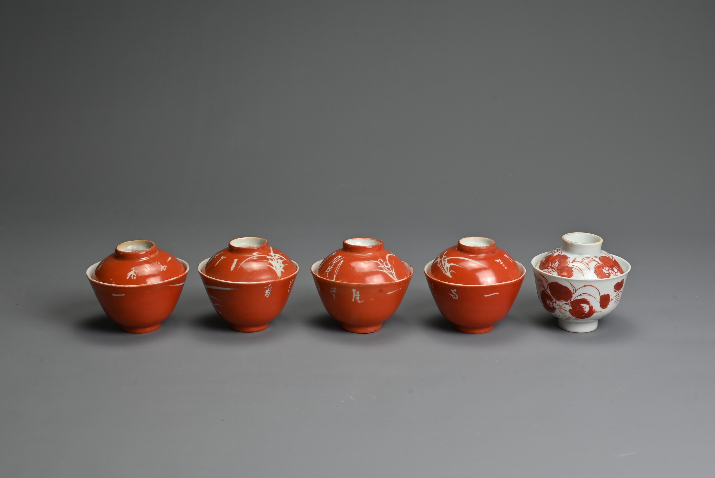 A GROUP OF CHINESE PORCELAIN CUPS AND COVERS, LATE QING DYNASTY. To include a set of four coral
