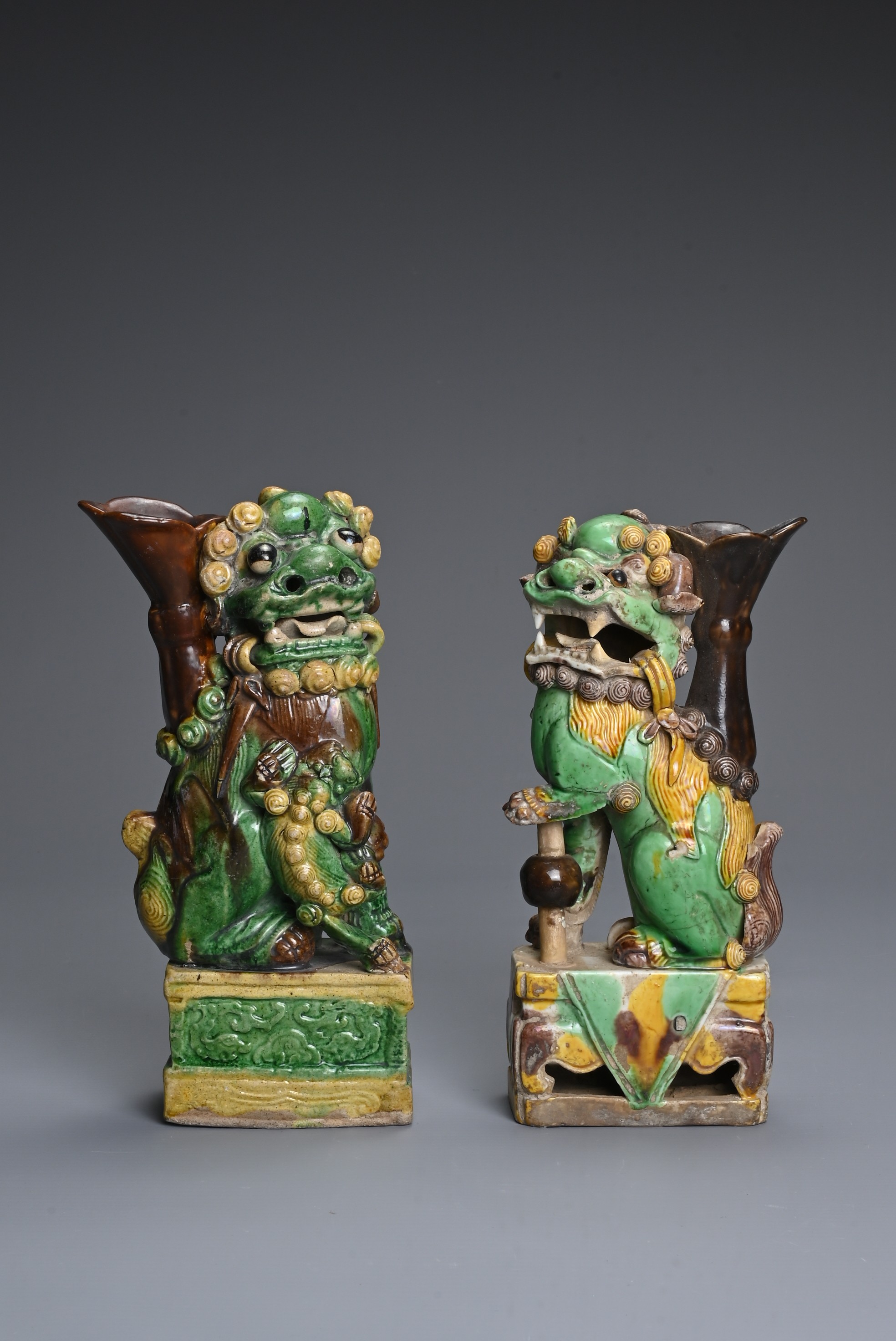 TWO CHINESE SANCAI GLAZED POTTERY JOSS STICK HOLDERS, QING DYNASTY. Buddhistic lions modelled seated