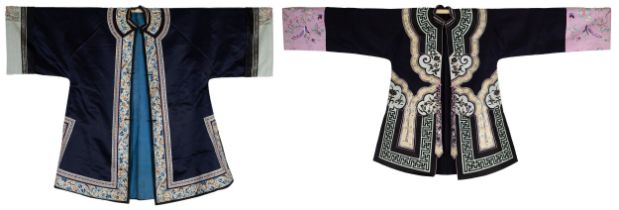 TWO CHINESE EMBROIDERED SILK ROBES, CIRCA 1920 AND LATER. The first, early 20th century, in dark