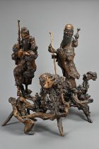 TWO VERY LARGE CHINESE ROOT CARVINGS, 19TH CENTURY. Sectional figures on stands of immortals and