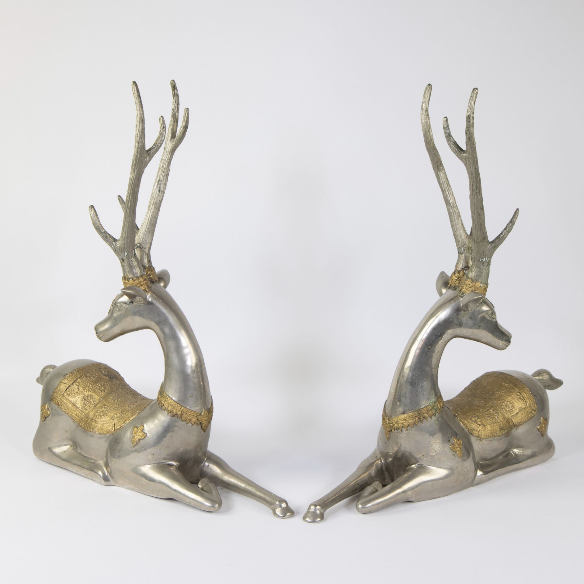 Pair of silver-plated and gilded deer in brass