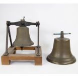 Lot of 2 bronze bells, one on a wooden frame