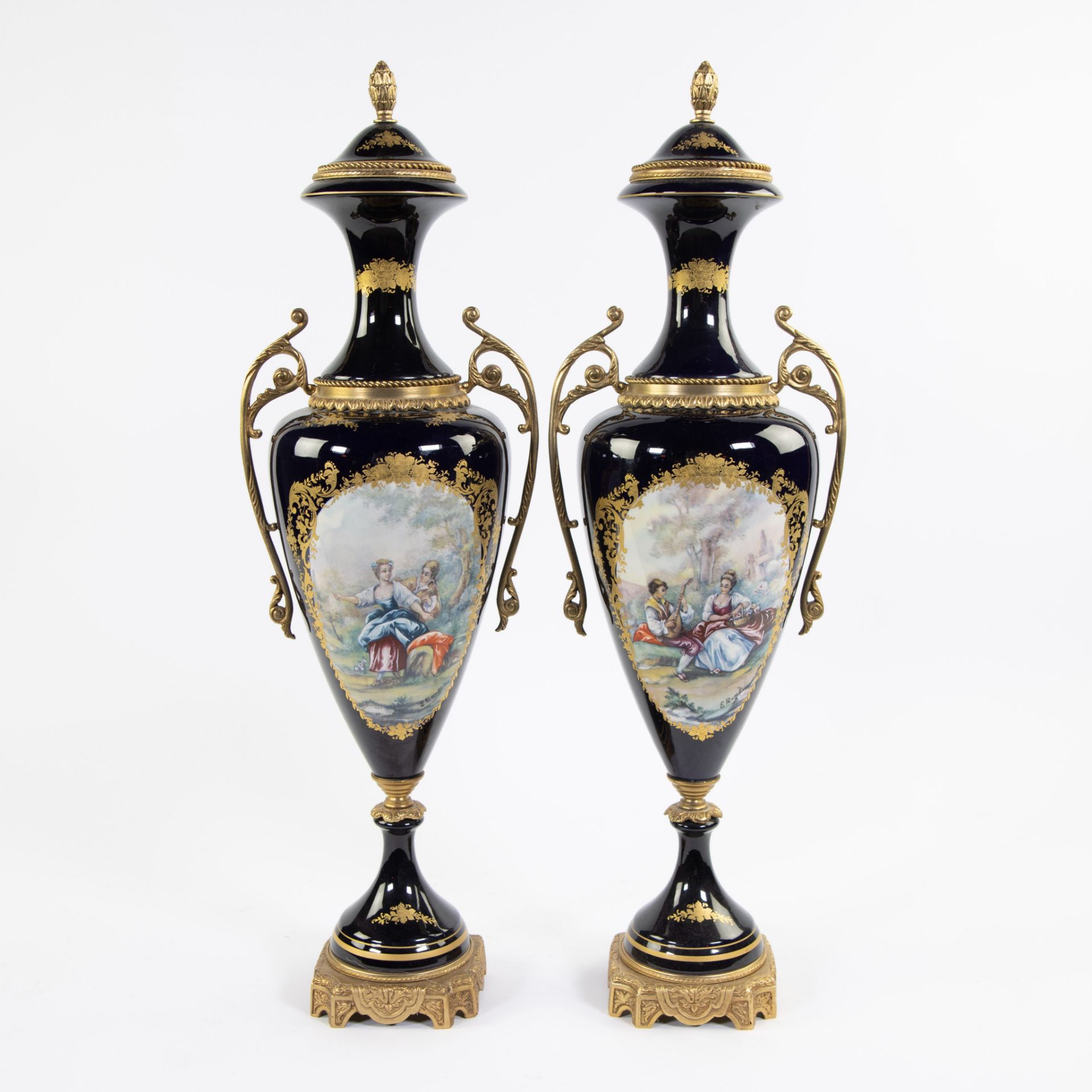 Pair of cobalt blue porcelain amphoras in Sèvres style with gold-plated ornaments Sèvres, signed E.