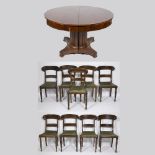 An extendable round Empire table made of acajou on a central columnar leg, on wheels and 9 chairs Ch