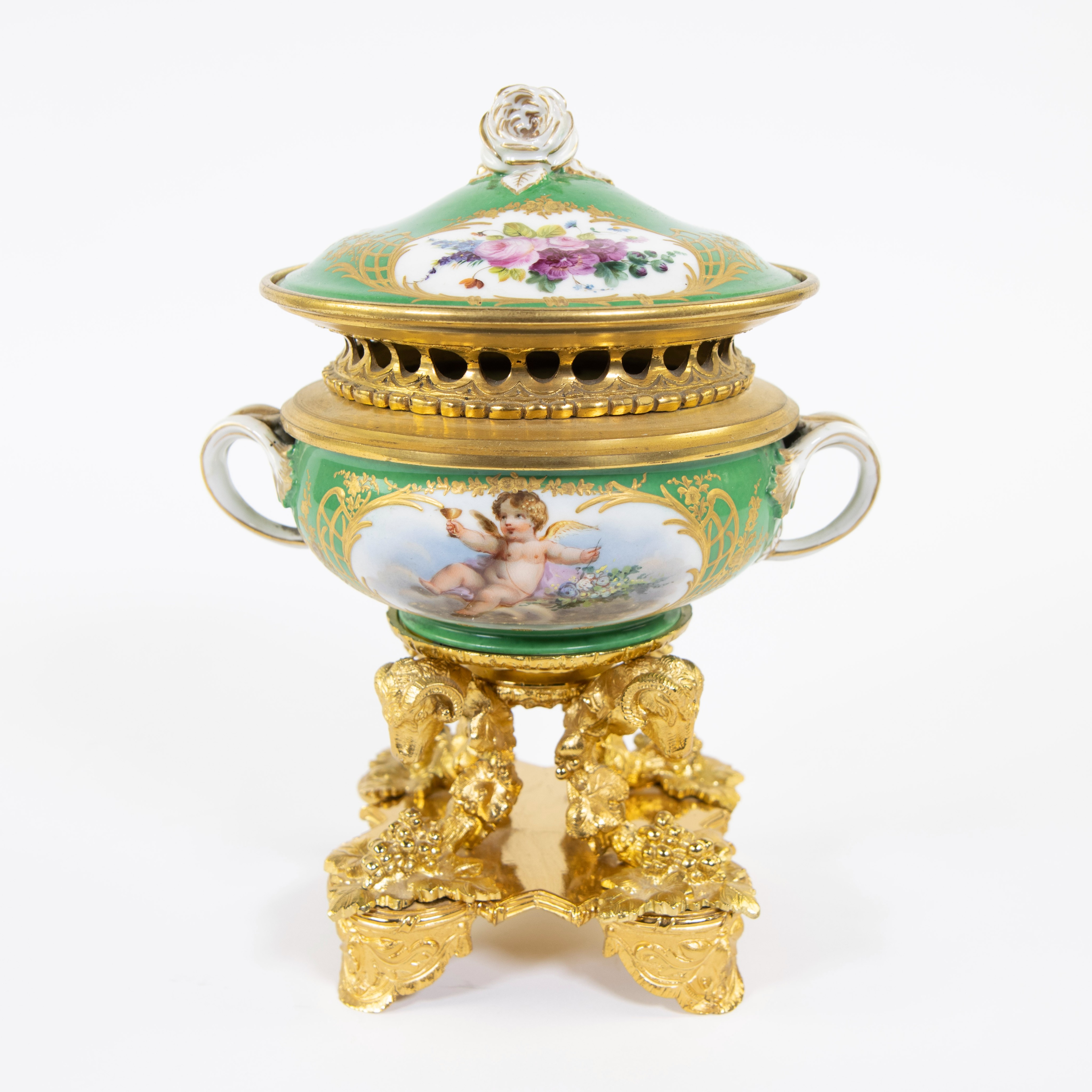 Porcelain table piece with gilt bronze fittings of rams' heads and bunches of grapes. Handpainted wi