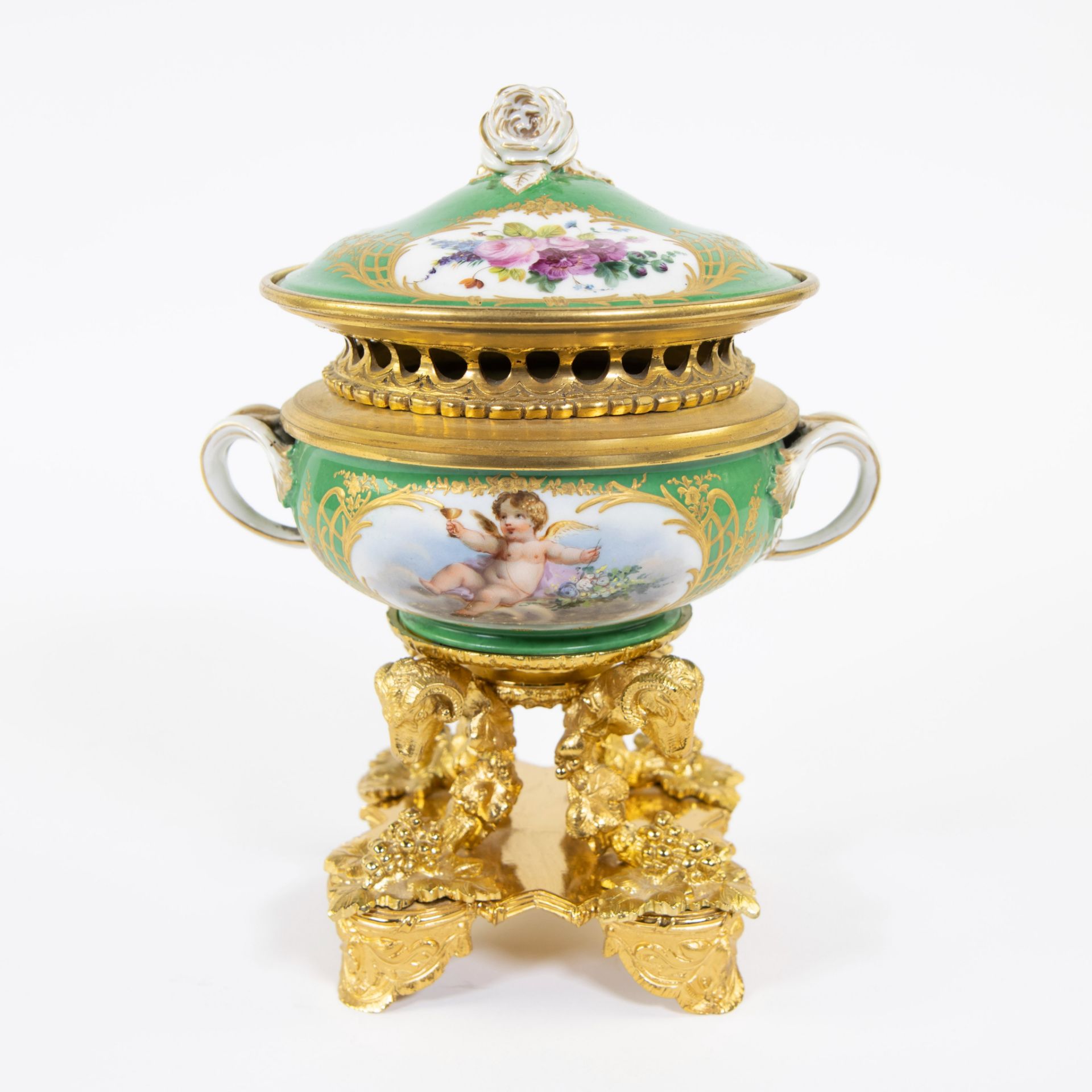Porcelain table piece with gilt bronze fittings of rams' heads and bunches of grapes. Handpainted wi