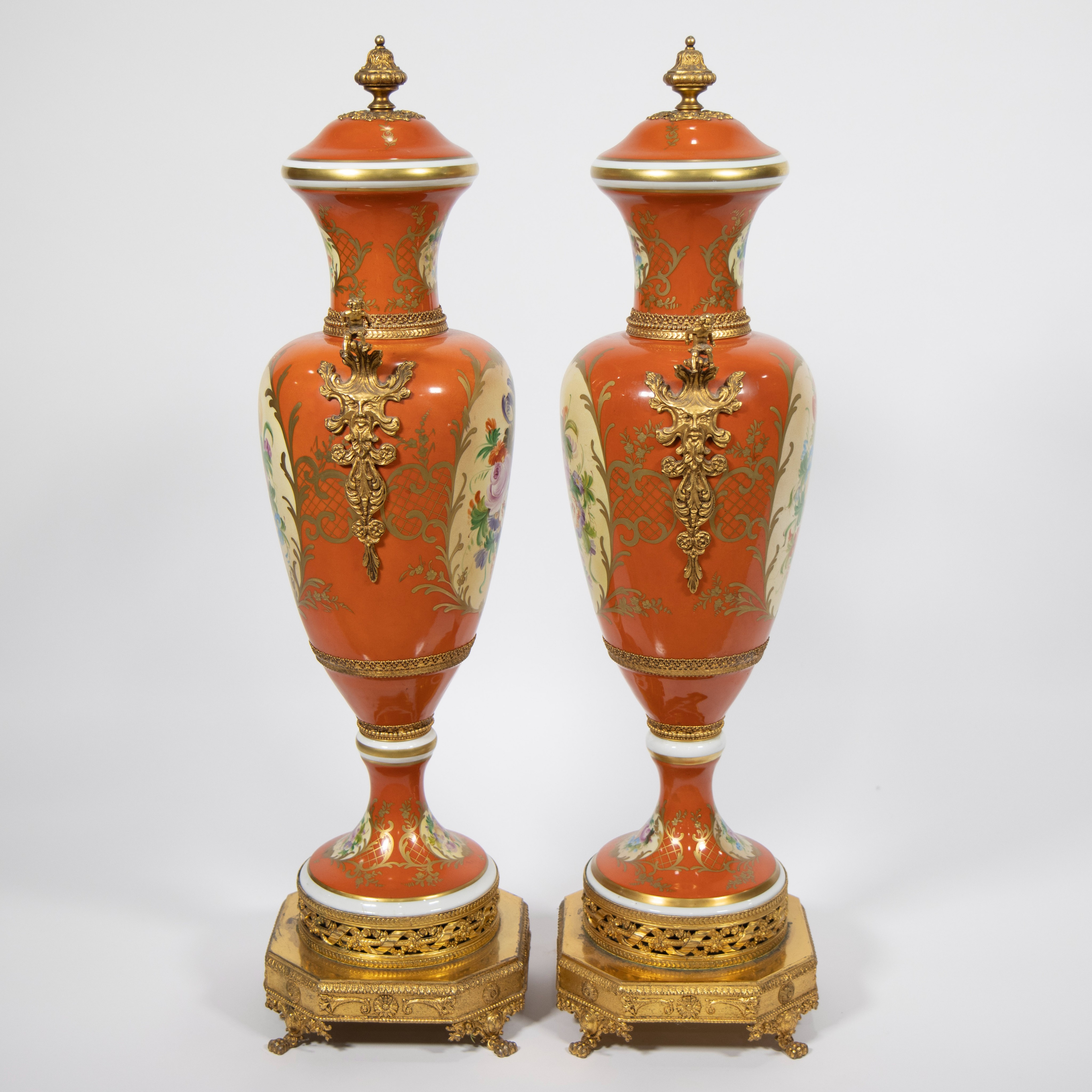 A pair of orange and polychrome porcelain covered vases with flowers and gilt bronze base and orname - Image 2 of 4