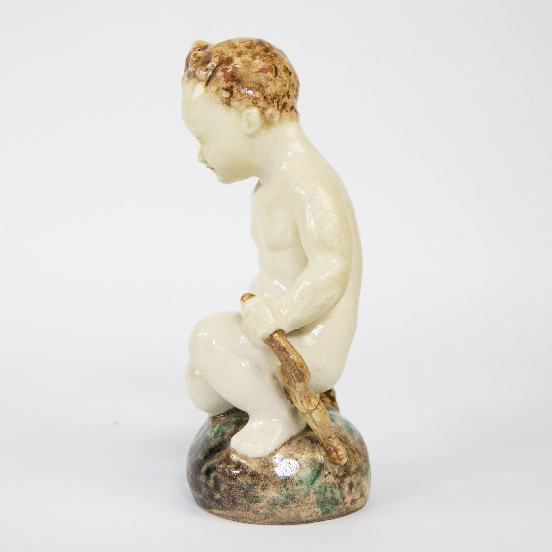 A ceramic figure of a seated child, Karlsruher Majolika, marked - Image 2 of 5