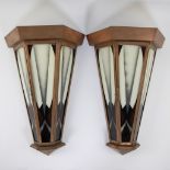 Beautiful pair of copper Art Deco wall lamps with colored glass and a sleek stylistic motif.