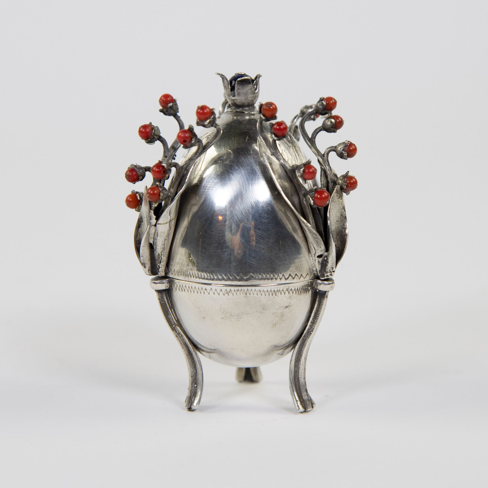 A Russian Silver Egg by Josef Sosnkowski. The egg is inset with flower stems inlaid with cabouchon r