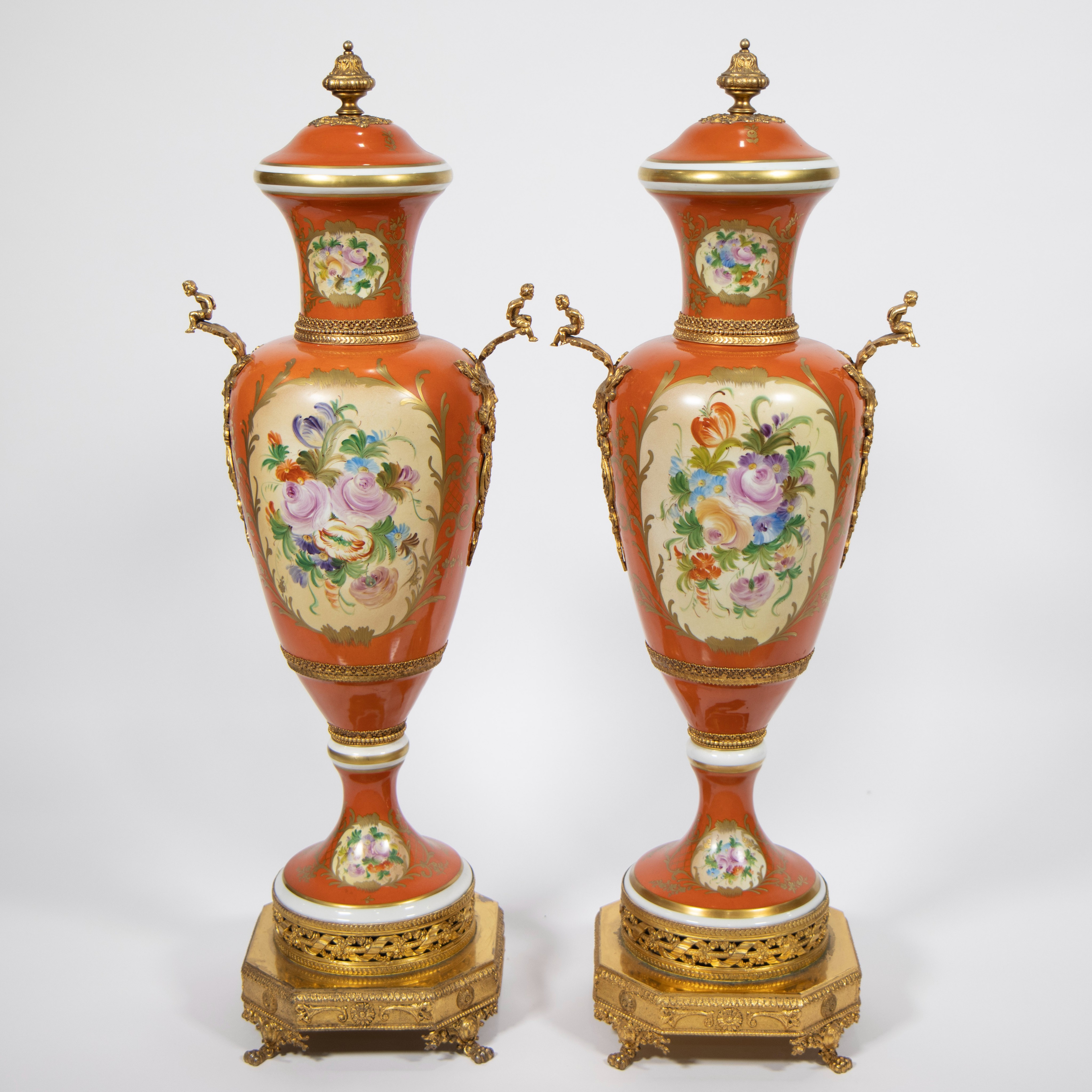 A pair of orange and polychrome porcelain covered vases with flowers and gilt bronze base and orname - Image 3 of 4